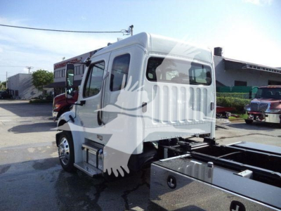 Truck cab of a 2027 Freightliner Business Class M2 106, side view, white cab, with chassis and wheels visible.