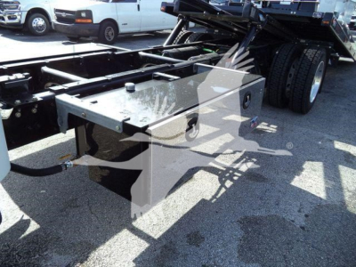 Freightliner M2 chassis toolbox and rollback bed area showing mounted metal toolbox and hydraulic lines.