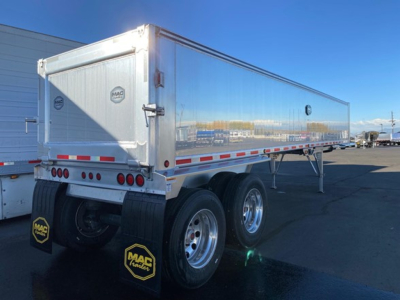 Mac trailer showing dual rear wheels, reflective tape, MAC brand logo on rear doors, and load space panel.