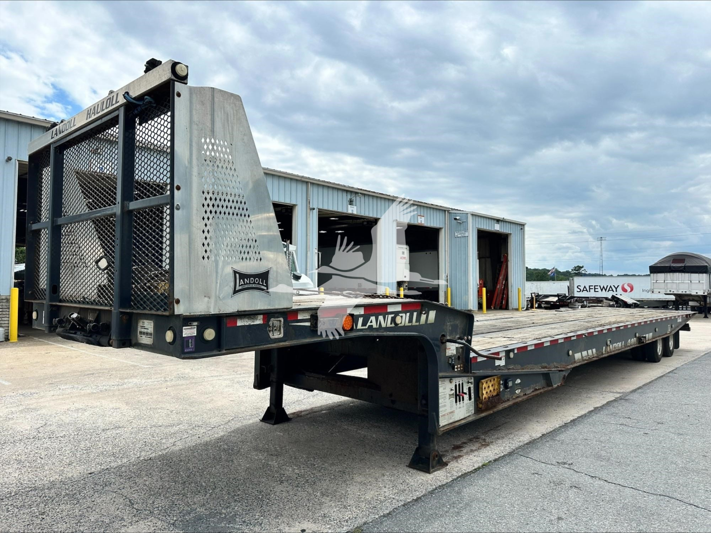 Landoll 440B trailer in service position showing steel deck and ramp with perforated steel guards.