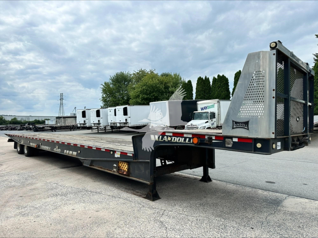 Landoll 440B trailer in a parking lot showing flatbed platform and detachable gooseneck at rear.