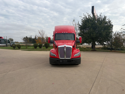 Kenworth T680 truck front view in red color with grille, headlights, and mirrors visible.