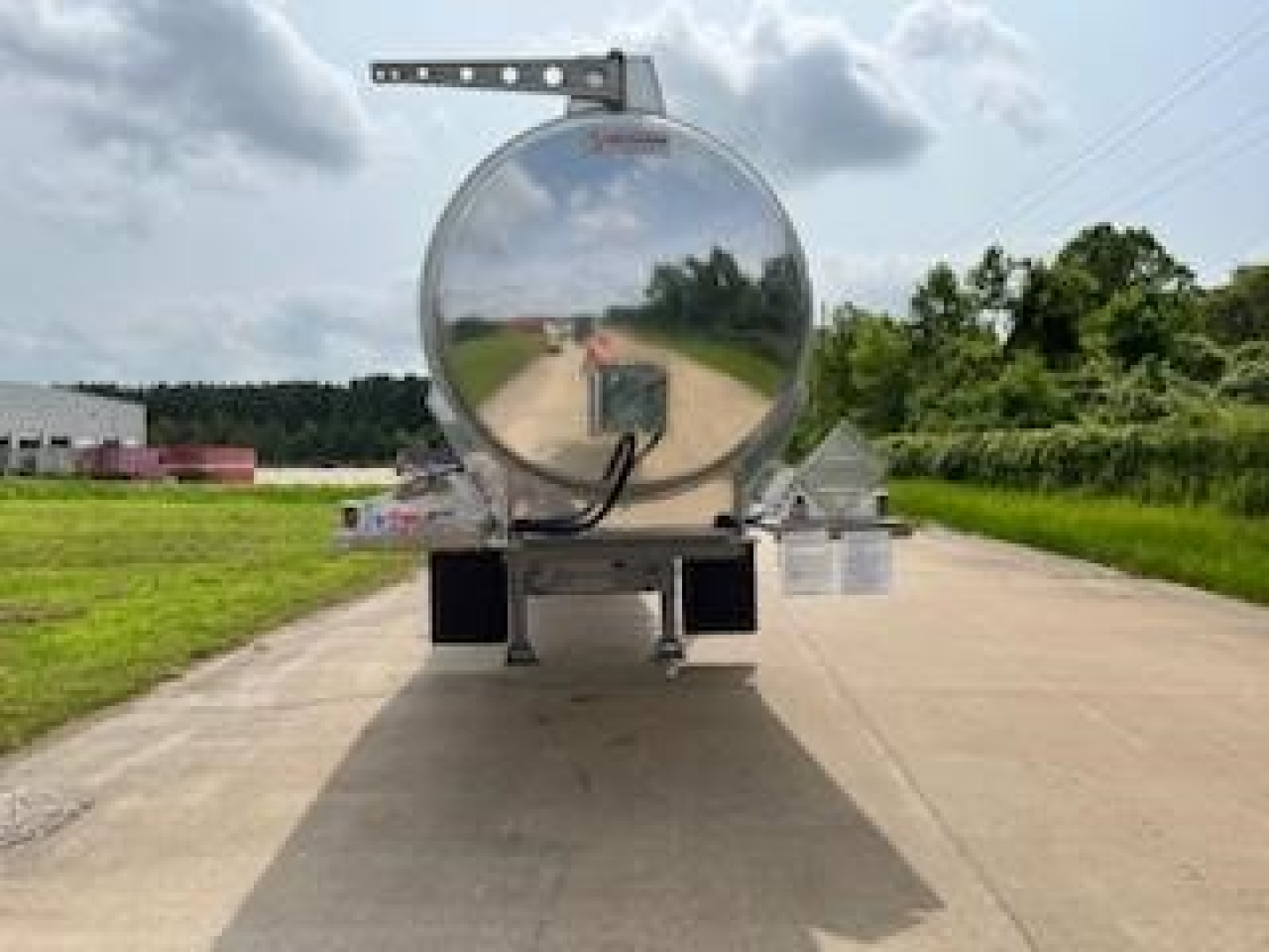 Tank trailer rear view showing polished cylindrical tank and mounting brackets.