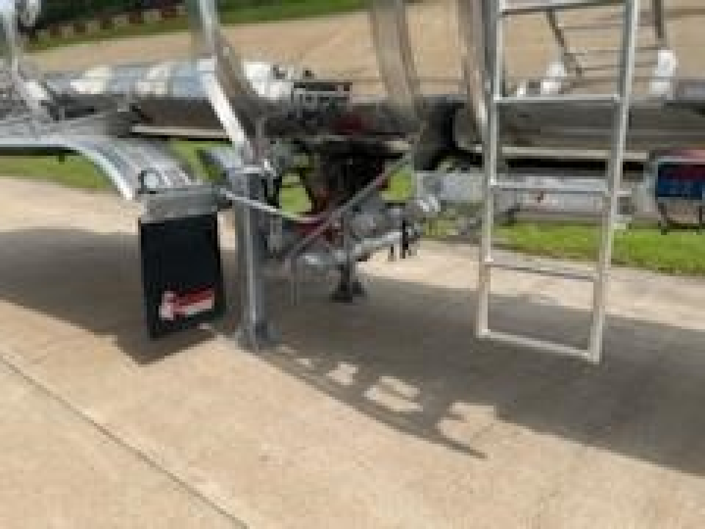 Trailer axles and dual tanks showing ladder and frame for 2026 Dragon 8400 GAL DC CRUDE trailer, side view.