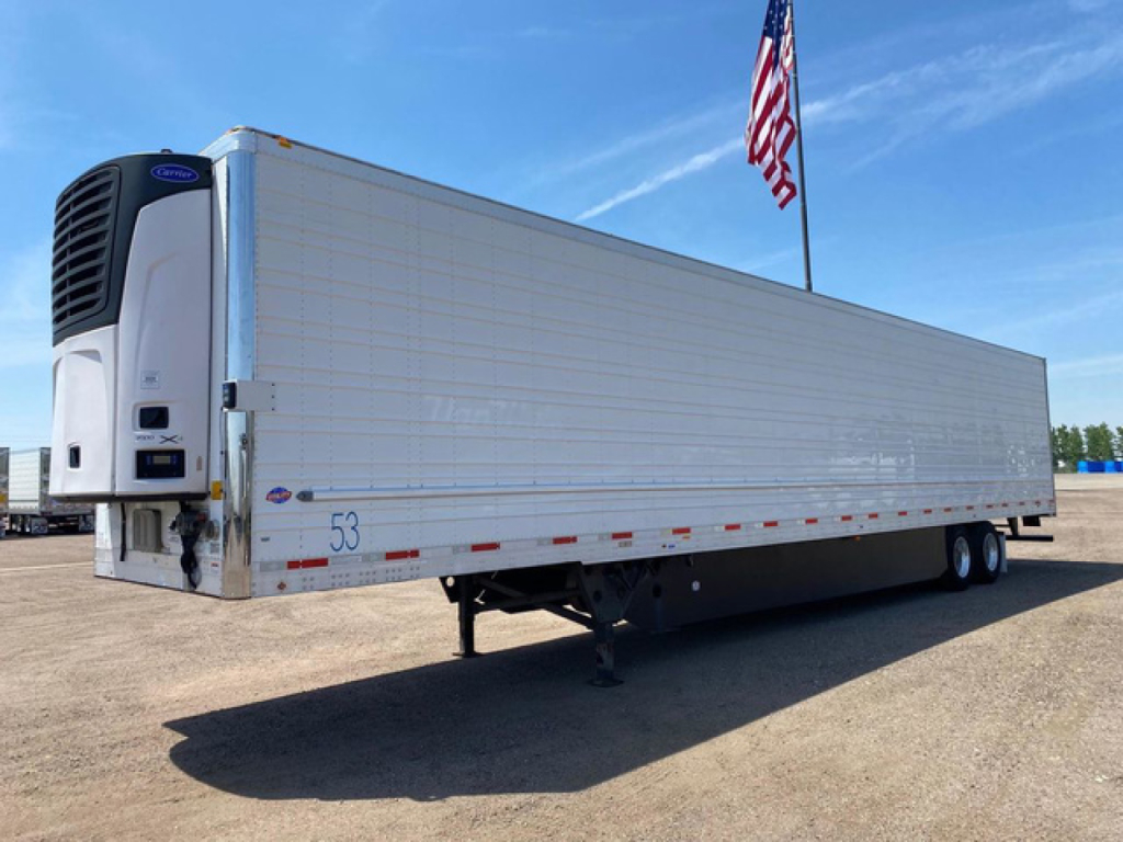 Trailer side view showing a refrigerated utility reefer trailer with Thermo King unit at front and a white metal exterior.