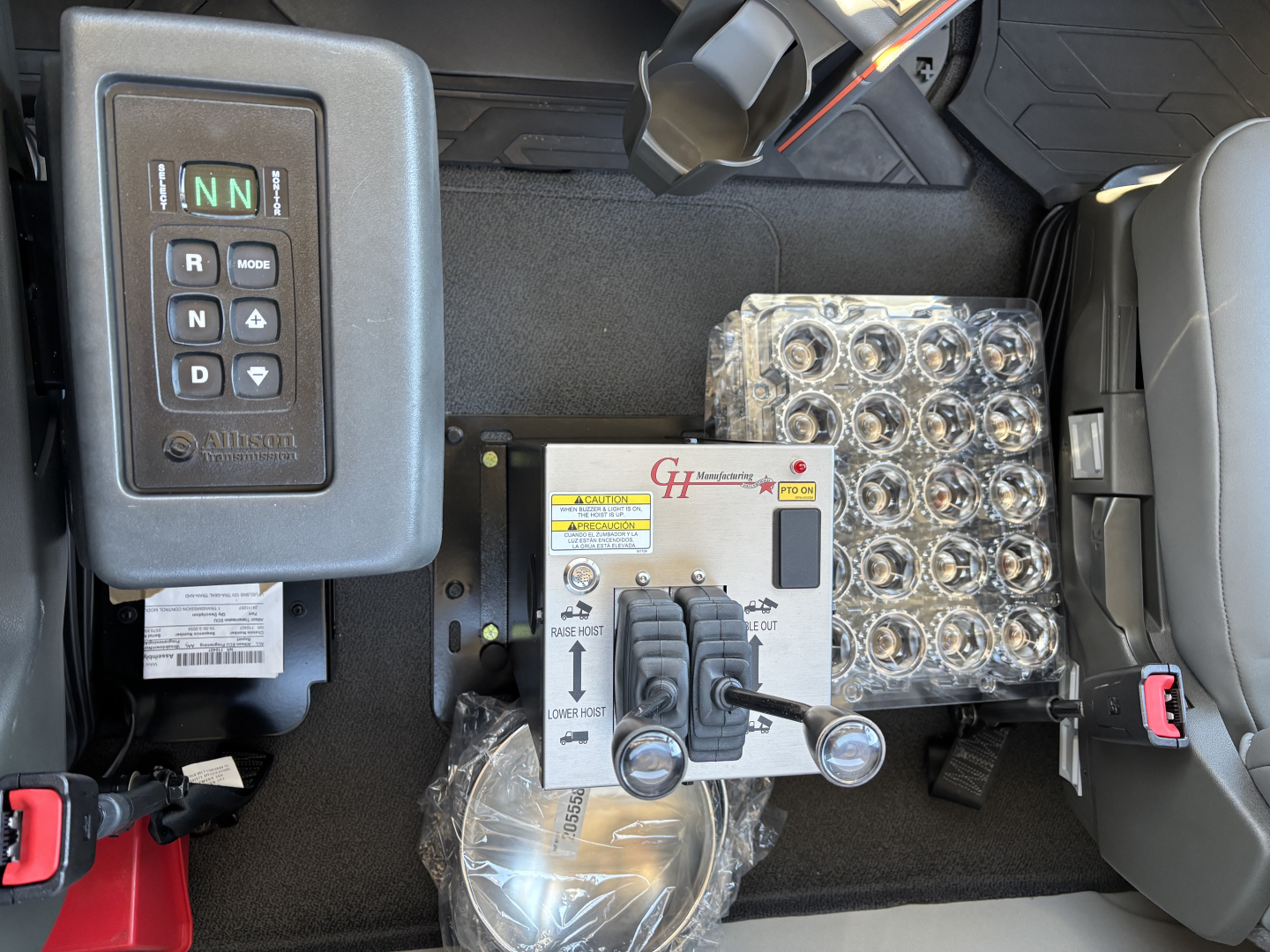 Volvo VHD64B300 cab interior showing shifter panel, joystick controls, and labeled hydraulic control module with multiple levers and circular connectors.