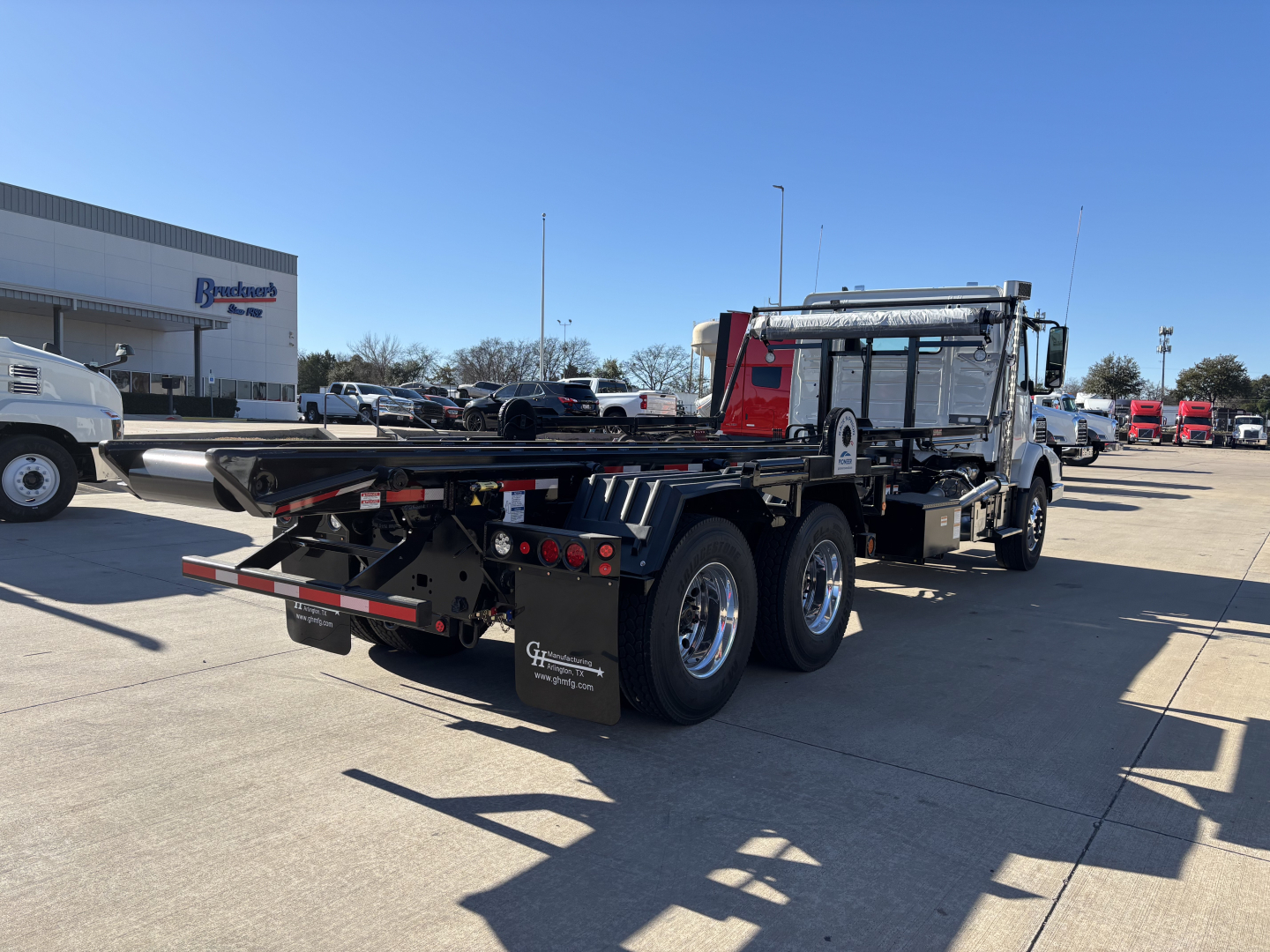 2026 Volvo VHD64B300 rolloff truck rear and side view showing chassis and dump bed area.