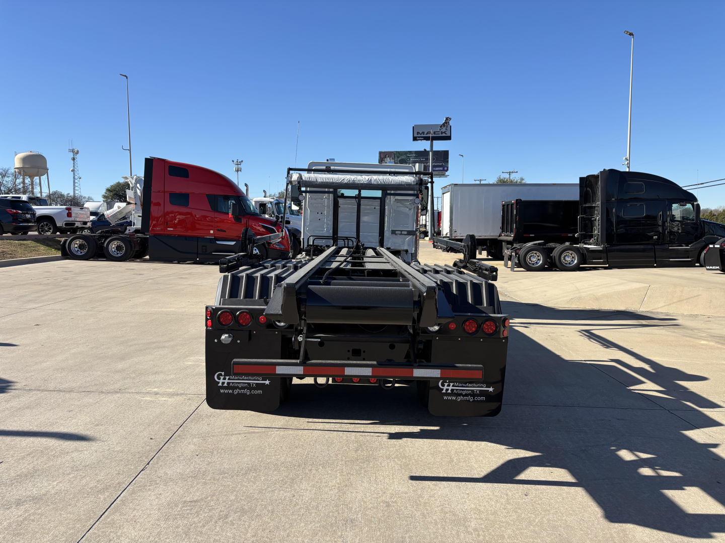Volvo VHD64B300 rolloff truck chassis back view showing heavy-duty frame and rear wheels