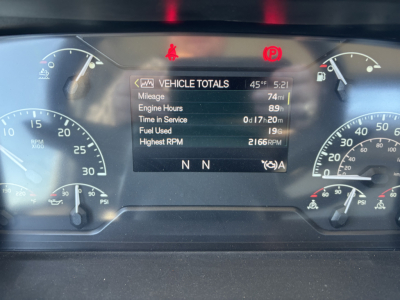 Dashboard display showing vehicle totals with mileage 74 mi, engine hours 8.9 h, time in service 0 h 17 m, fuel used 19 gal, highest RPM 2166, and warning lights.