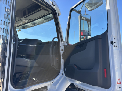 Volvo VHD64B300 rollover truck cabin interior and open door showing front seat and door panel with side mirror reflection
