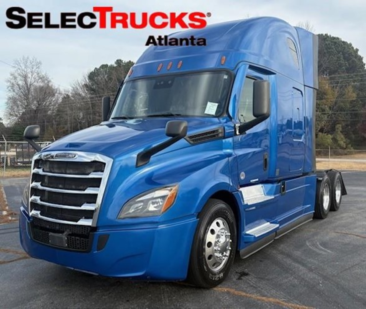 Blue Freightliner Cascadia 126 truck in showroom lot showing exterior with SelectTrucks Atlanta branding