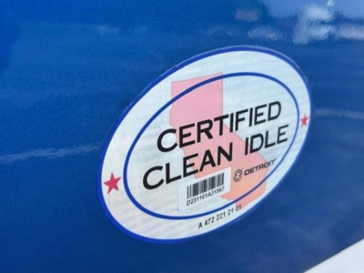 Sticker on blue truck showing Certified Clean Idle with Detro logos and background circular design.