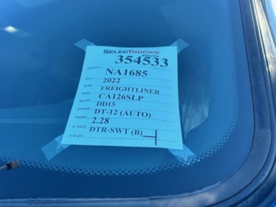 Sticker on windshield with stock number 354533, VIN NA1685, 2022 Freightliner Cascadia 126SLP, DD15 engine, 2.28 transmission?, DT-12 (AUTO).