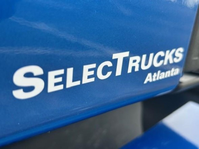 Select Trucks Atlanta logo on blue cab surface.