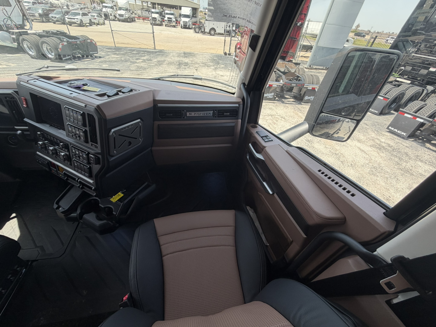 Mack PR64T76H truck cab interior with dashboard and steering wheel visible.