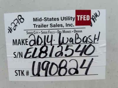A label on a trailer showing MFUT/TFED branding and handwritten data: ‘MAKE 2014 WABASH’ S/N EL812540 STK # U90824.