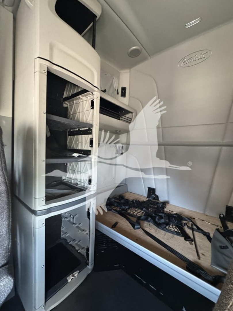 Peterbilt 579 sleeper cab interior showing storage shelves and cargo area with side wall panel and window