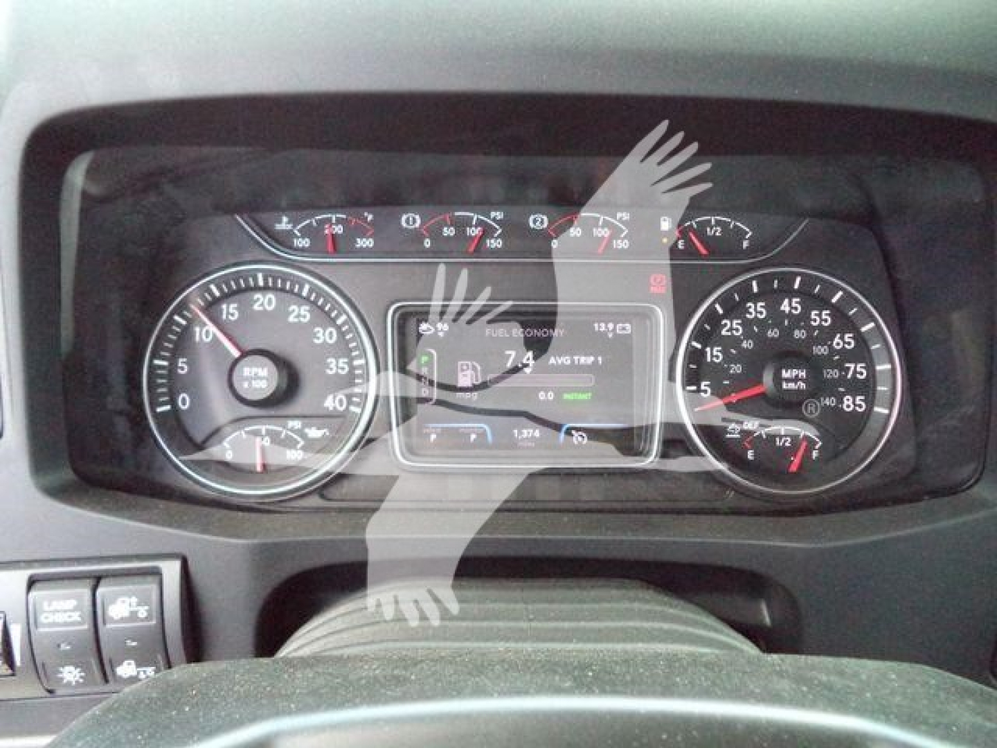 Dashboard view of a 2026 International MV truck showing analog gauges and a central digital display.