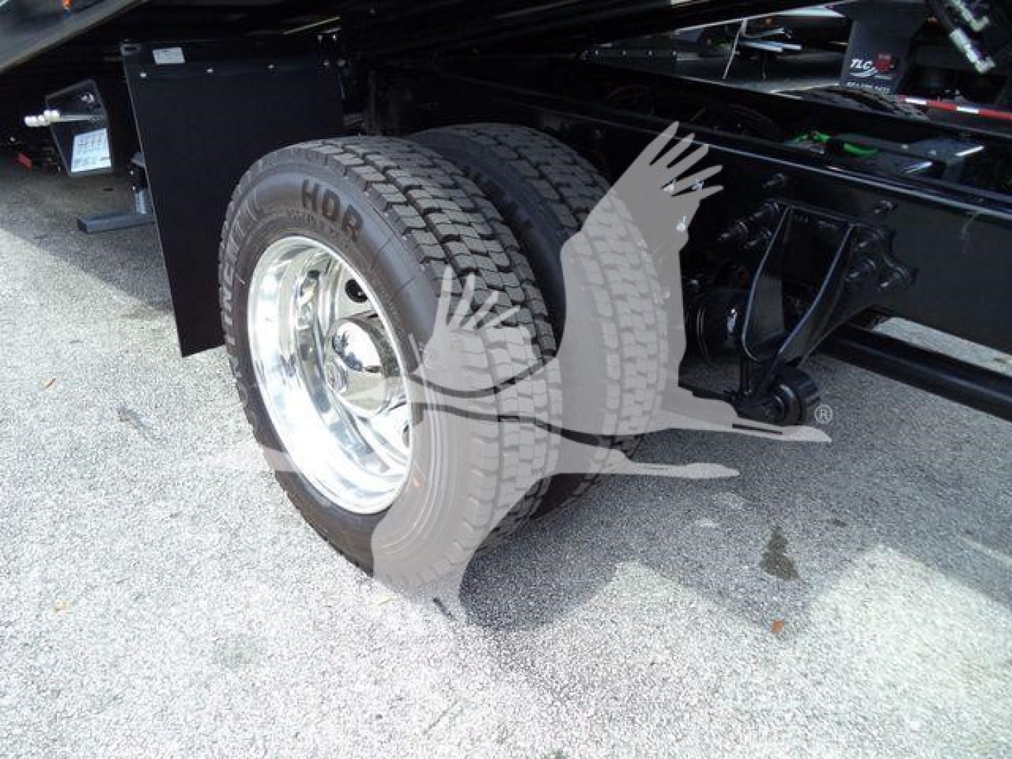 Truck rear wheel assembly showing dual tires and suspension undercarriage of a 2026 International MV rollback truck.