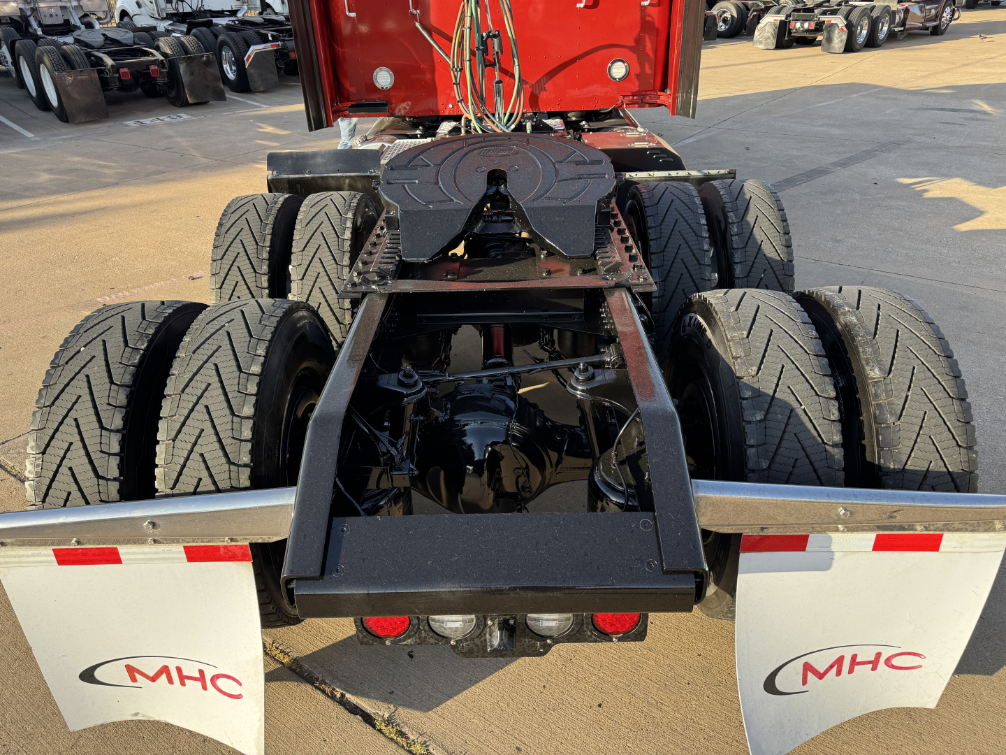 Kenworth W900L rear chassis and fifth wheel area showing dual rear twin axles and suspension components.