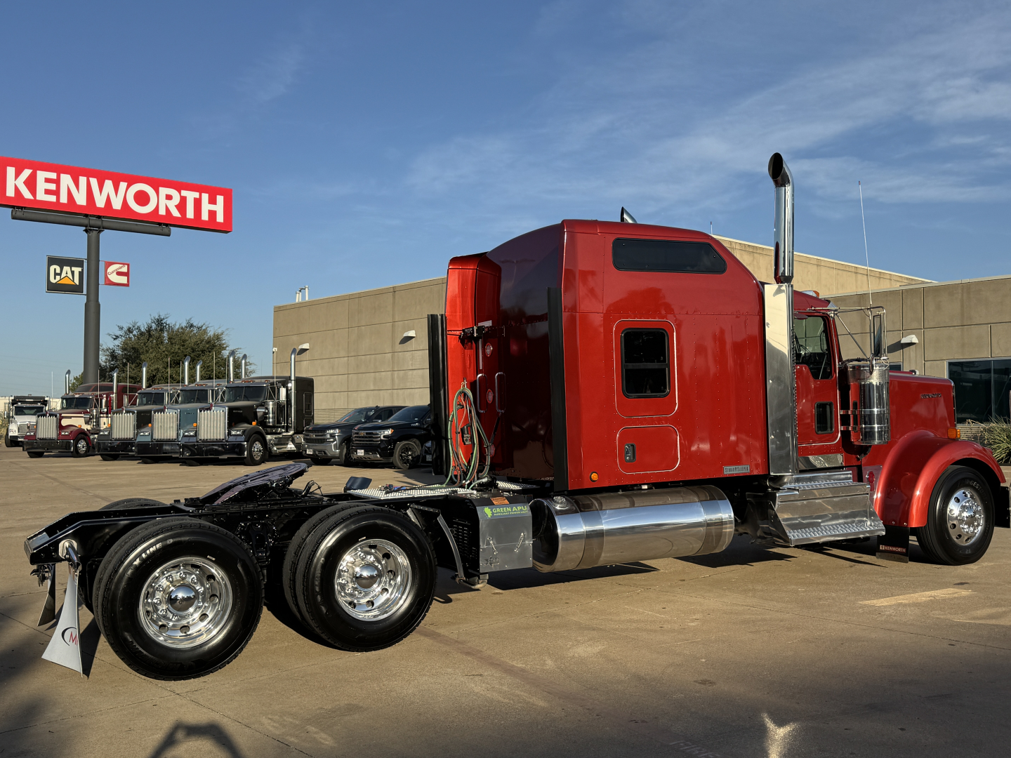 Kenworth W900L conventional sleeper truck with red cab and chrome dual exhaust stacks, viewed from side; VIN 1XKWD49X0SR121295 stock 0629911 visible in listing context.