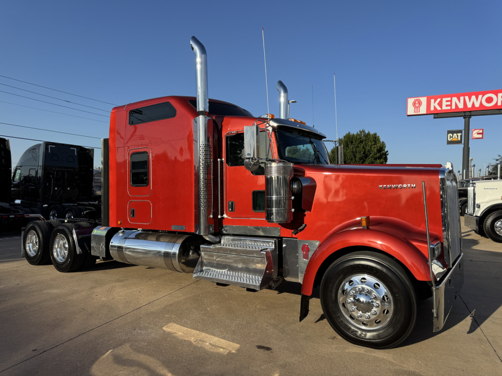 Kenworth W900L conventional sleeper tractor with red paint, chrome exhaust stacks, front chrome bumper, large front fender and twin rear axles.