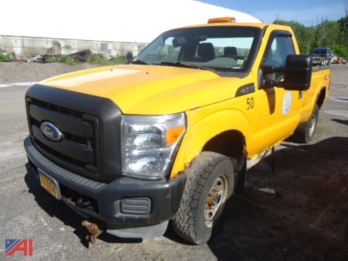 Ford F-250 Super Duty pickup truck in yellow with 4x4, front view showing grille, bumper, and side mirror; number 50 on door.