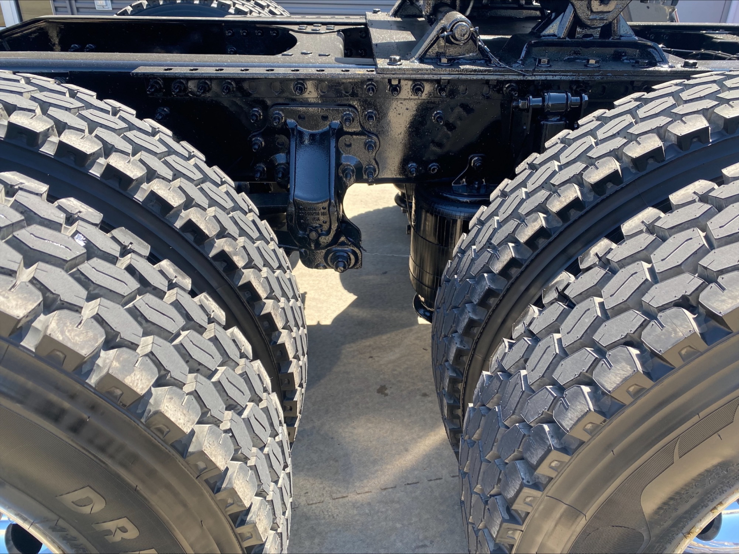 Mack ANTHEM truck chassis rear view showing dual rear axles and heavy-duty suspension components.