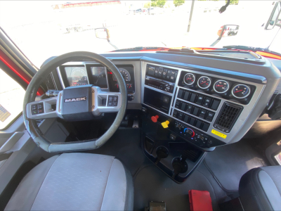 Mack Anthem truck interior cockpit showing steering wheel, dashboard gauges, and control panel.