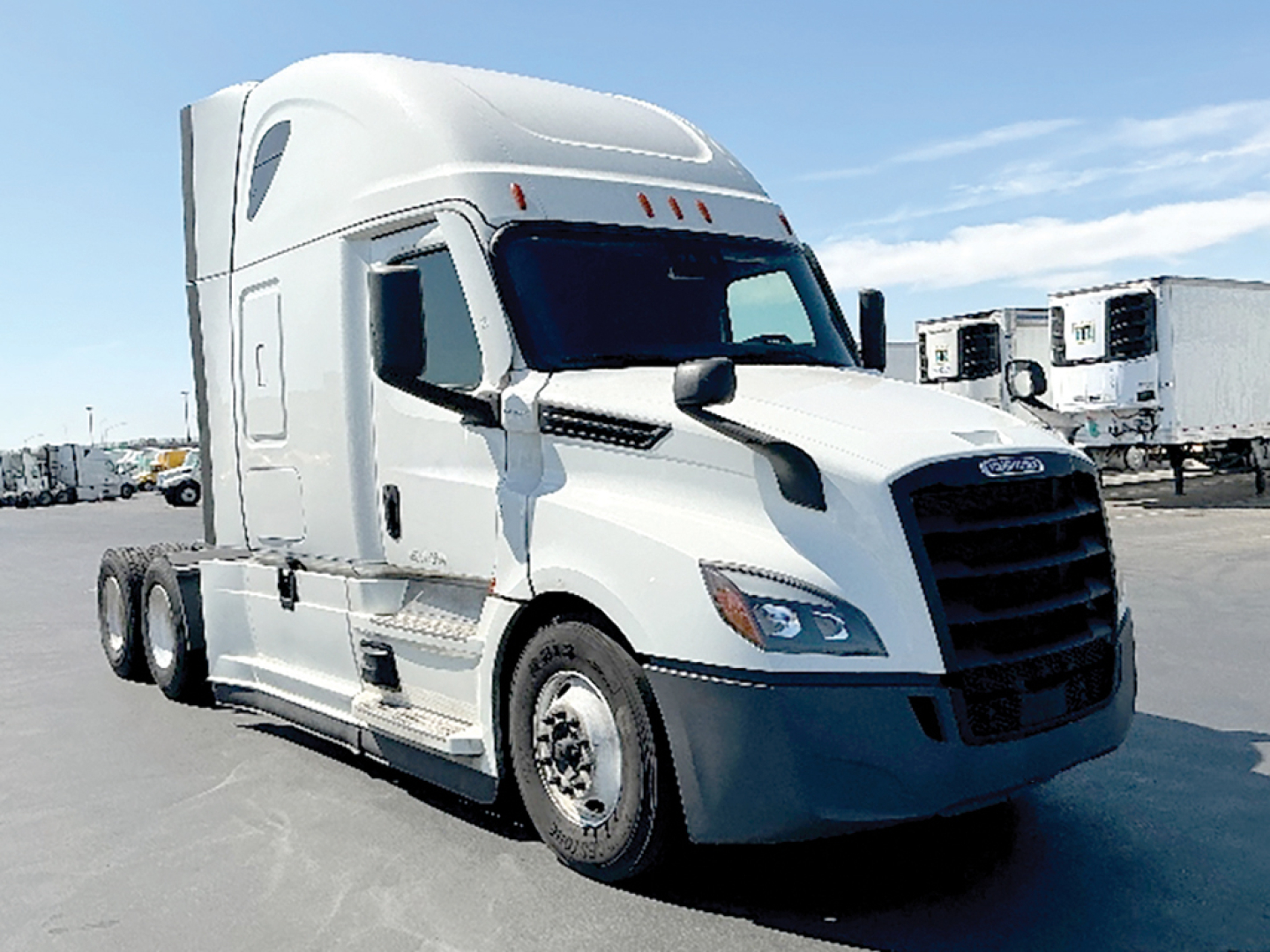 Truck cab showing 2021 Freightliner Cascadia126, white sleeper with black grille, side mirrors, bumper and 3-axle tractor; visible VIN tag and stock number not legible.