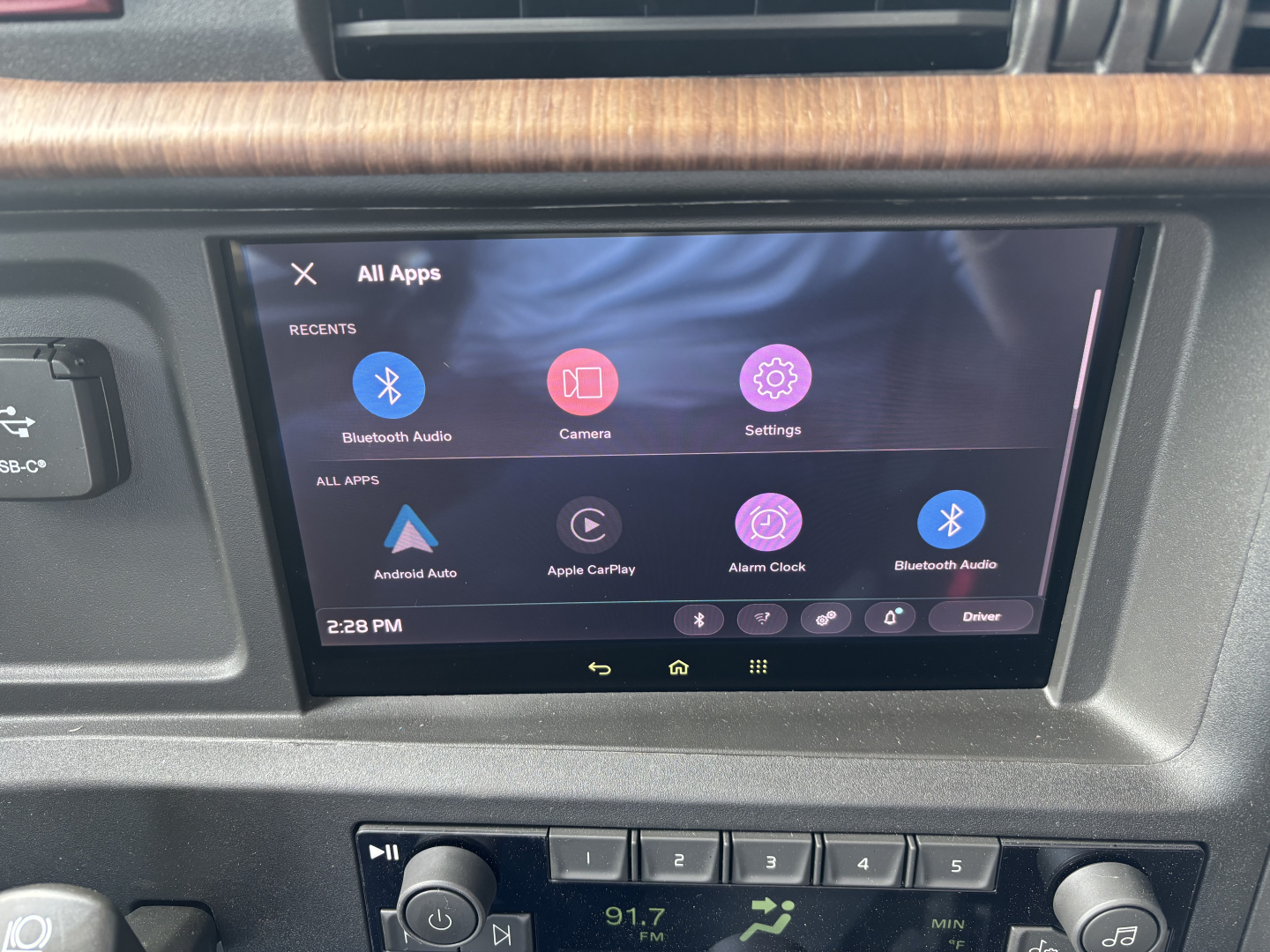 Volvo VNL interior dashboard with center touchscreen displaying Android/Apps menu and climate controls.