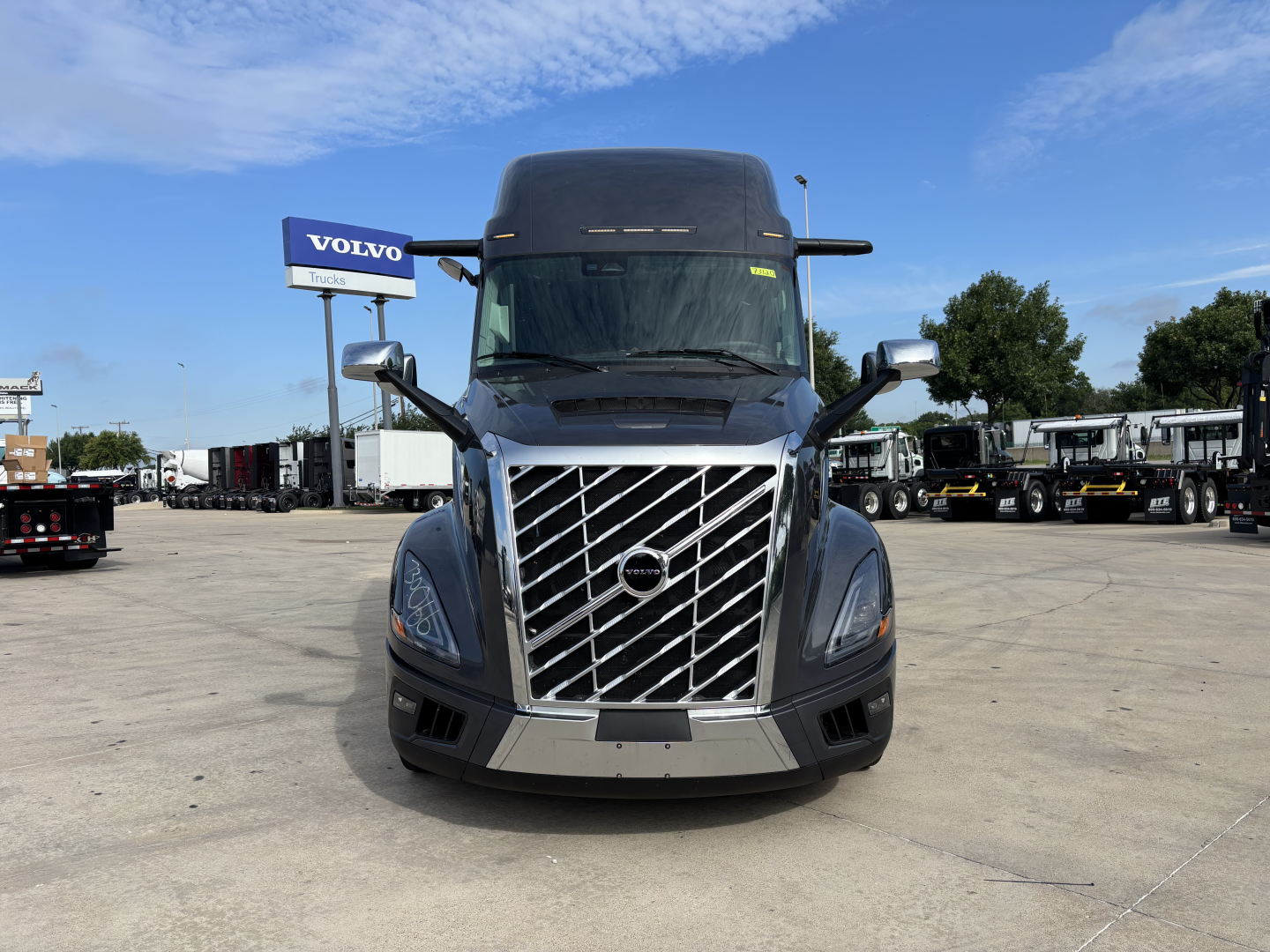 Volvo VNL64T860 tractor front view showing chrome grille and Volvo badge.