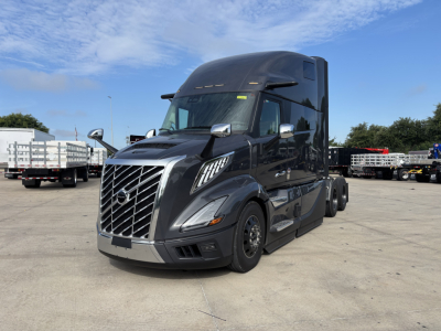 Volvo VNL64T860 conventional sleeper tractor showing front grille badge and side mirrors.