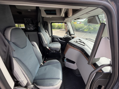 Volvo VNL64T860 interior cab with driver and passenger seats, dashboard, and steering wheel.