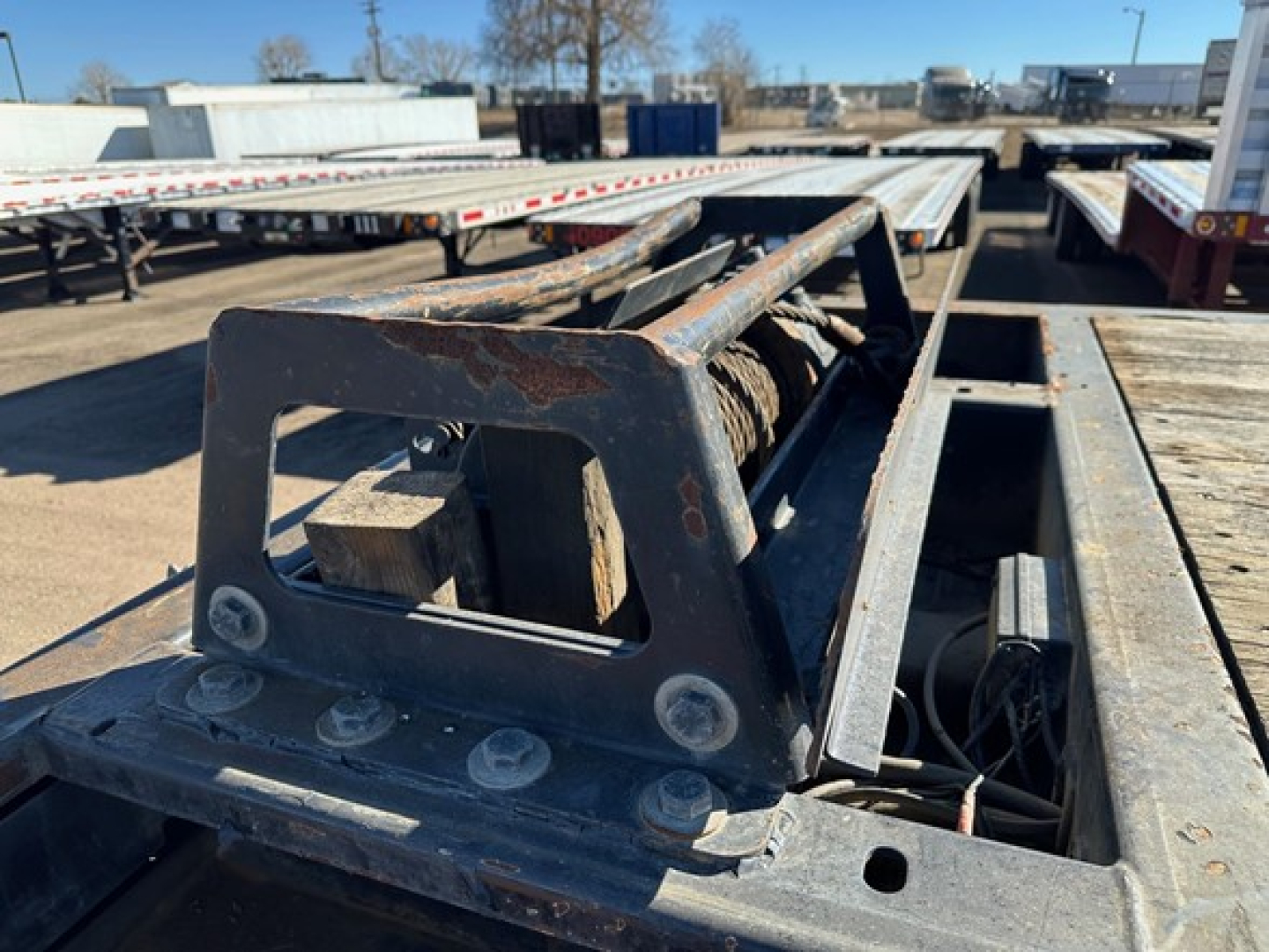 Trailer hitch/frame close-up showing welds and steel beam on 2021 Trail-Eze 40TON hydraulic tail with winch and upper deck.