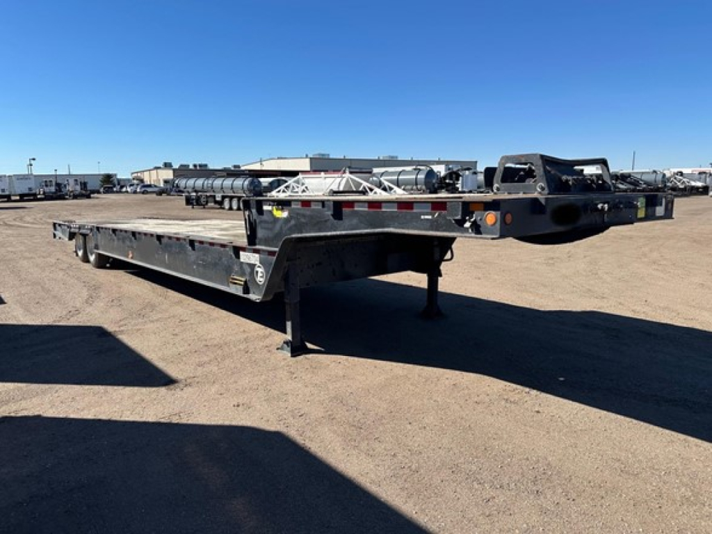 Trail-Eze 40 ton hydraulic tail trailer with air ride and winch on upper deck, black frame, parked in lot; visible markings and reflections.
