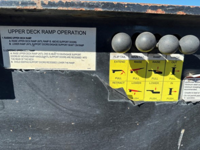 Upper deck ramp operation decals on a Trail-Eze 40-ton hydraulic tail trailer showing push/pull controls and warning labels.