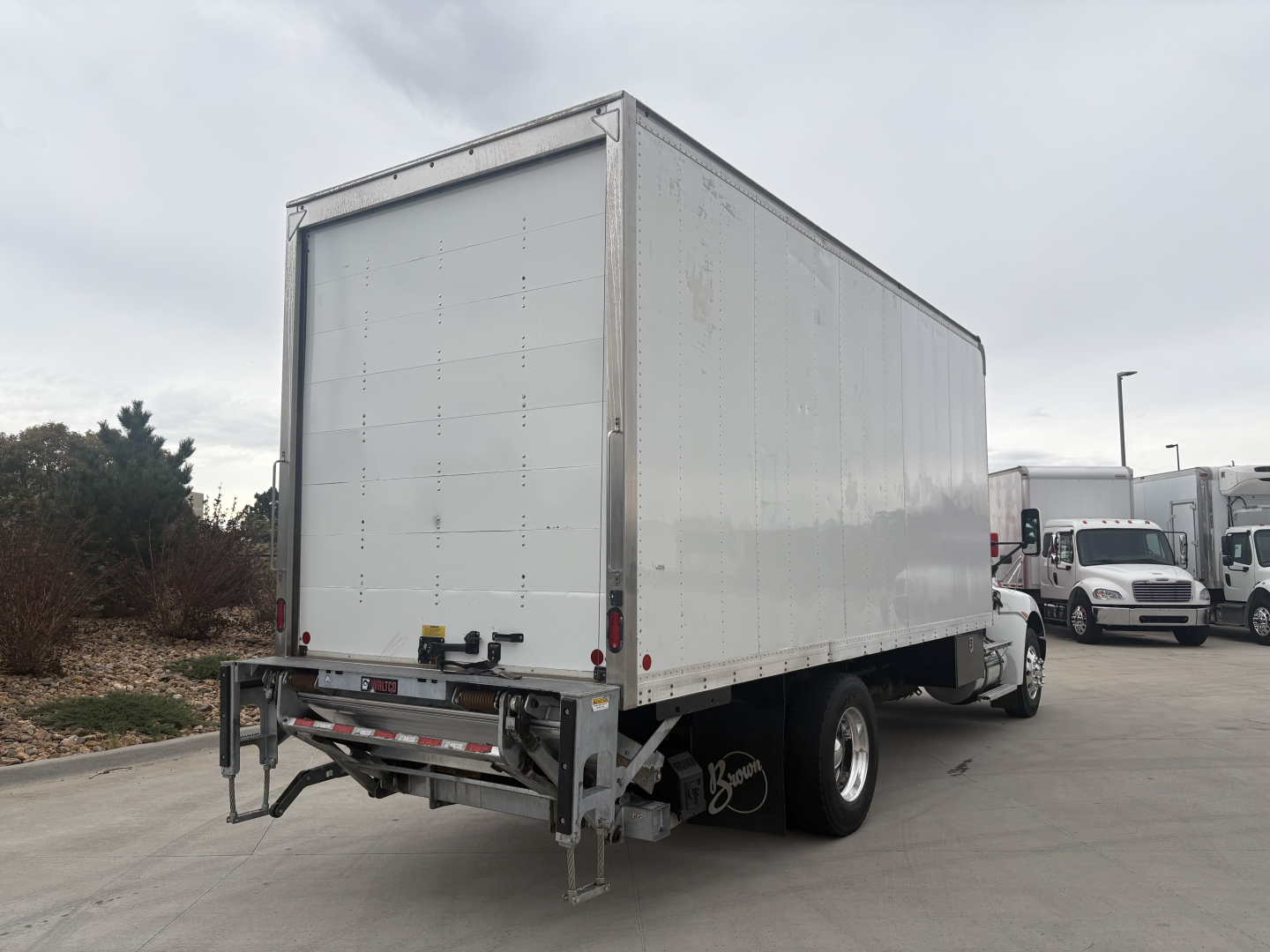 Kenworth T270 box truck rear with cargo box and rear bumper and wheels visible