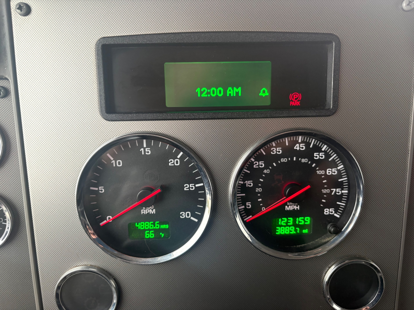 dashboard gauges and digital display in Kenworth T270 showing RPM gauge, speedometer, and green digital readouts.