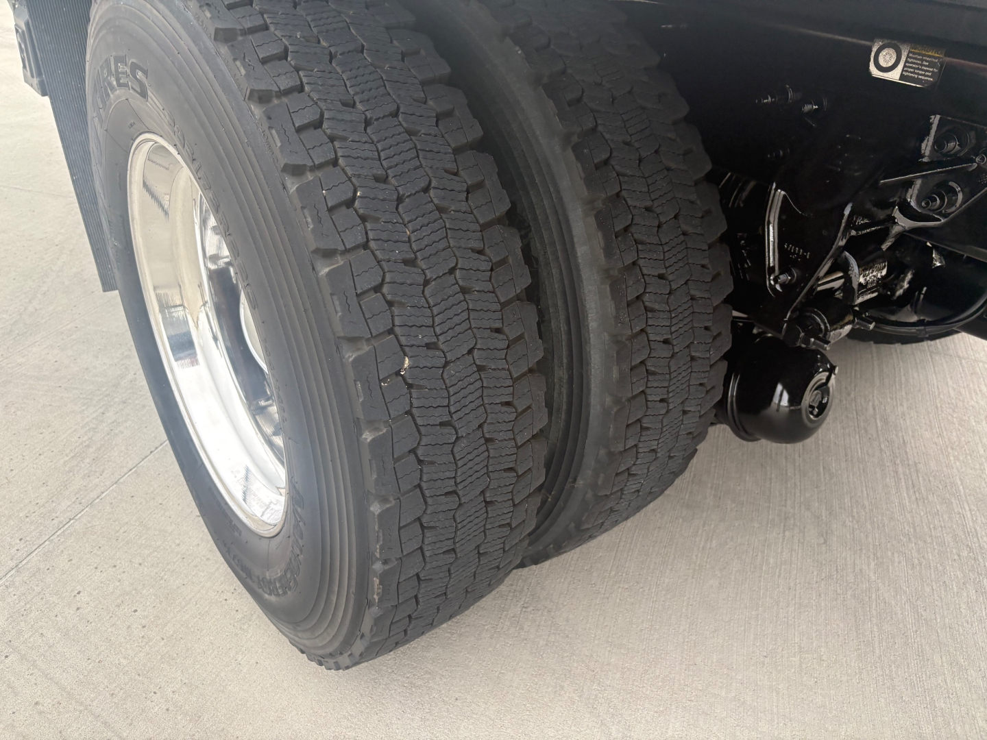 Front wheel and dual tires of a Kenworth T270 truck showing wheel, tire treads, and suspension components.
