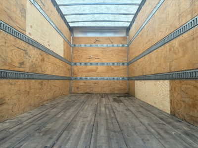 Kenworth T270 cargo truck box interior showing wooden walls and metal tie rails along the sides.