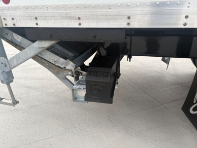 Kenworth box truck tail area showing bumper, undercarriage, and storage hitch with Vinco or similar black box and metal frame and wiring.