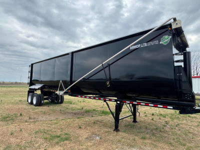 Armor Lite trailer showing a black 40' x 100" dump trailer with dual rear axles and landing gear. Armor Lite logo visible on side.