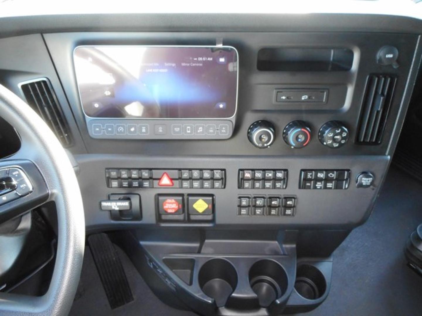 Dashboard of a 2026 Freightliner Cascadia 126 truck showing infotainment screen, climate controls, and switch panel.