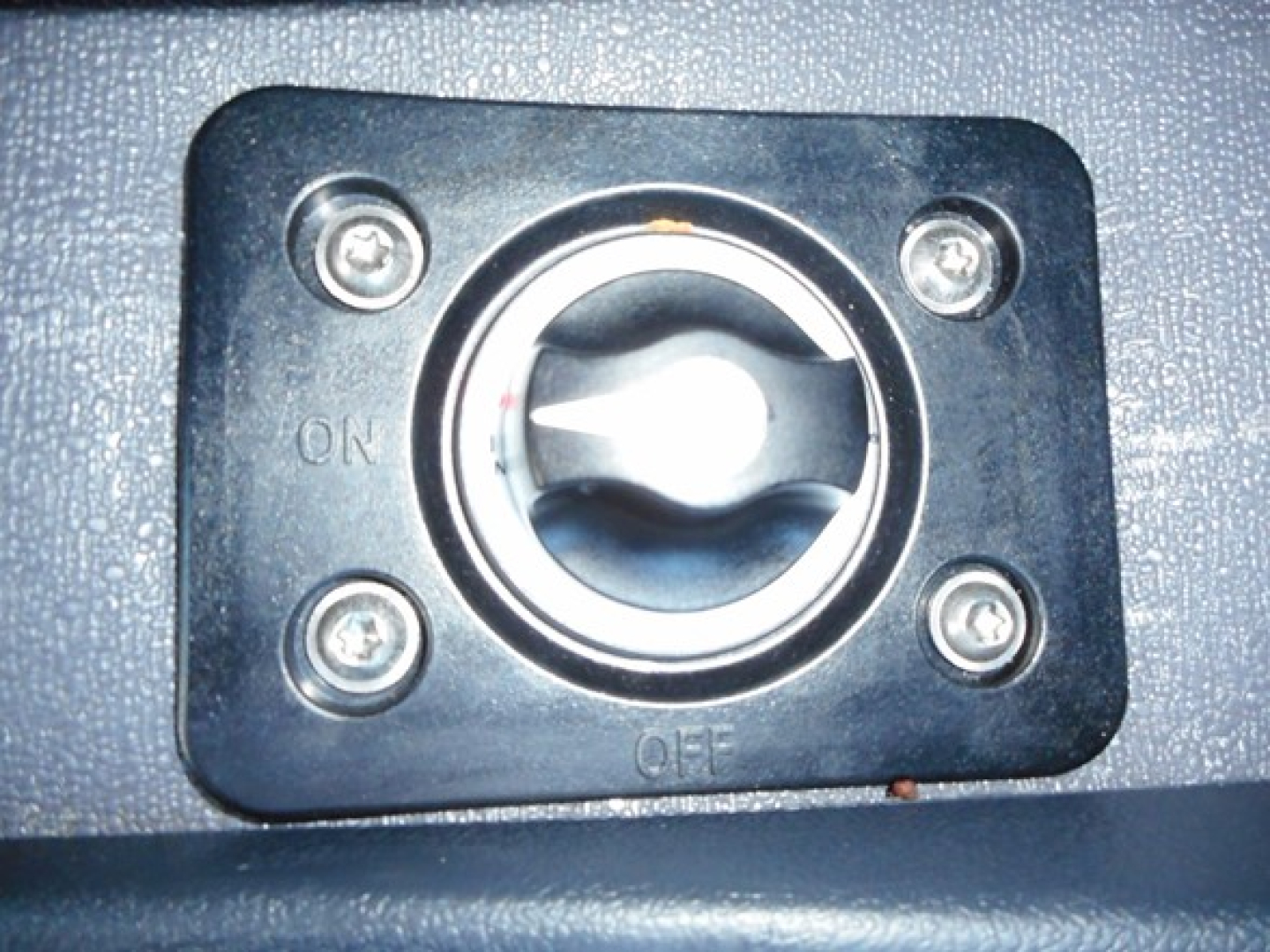 Fuel cap/ashifting switch panel with ON and OFF markings and four screws visible.