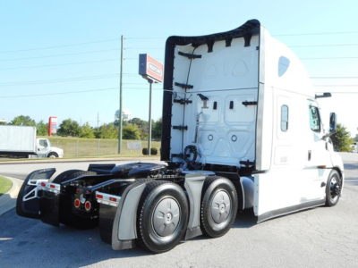 Freightliner Cascadia 126 tractor rear view showing sleeper cab, rear wheels, and fifth wheel mounting with chassis components.