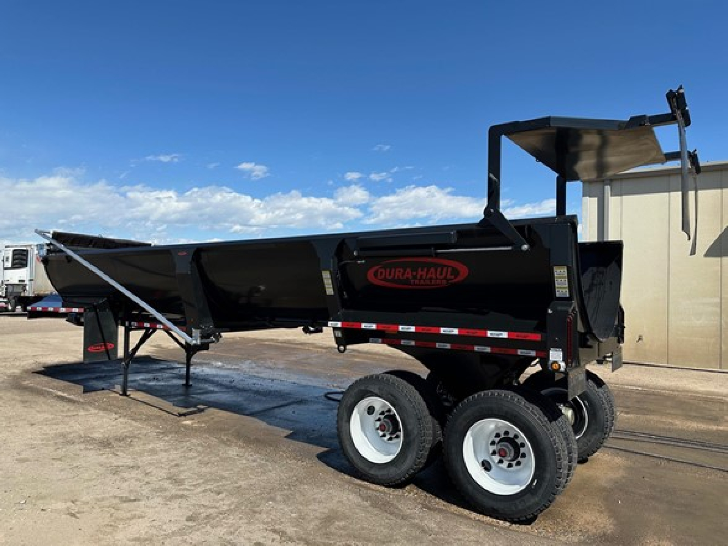 Dura Haul rock tub dump trailer in black with dual rear wheels and hydraulic dump bed showing NE10531 stock number and Dura-Haul logo on side.