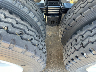 Rear view of 2026 Dura Haul Rock Tub Frameless End Dump trailer showing dual heavy-duty tires, axle area, and suspension components.