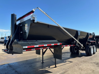 Frameless end dump trailer in side view showing support legs and dual rear axles with black body and reflective striping.