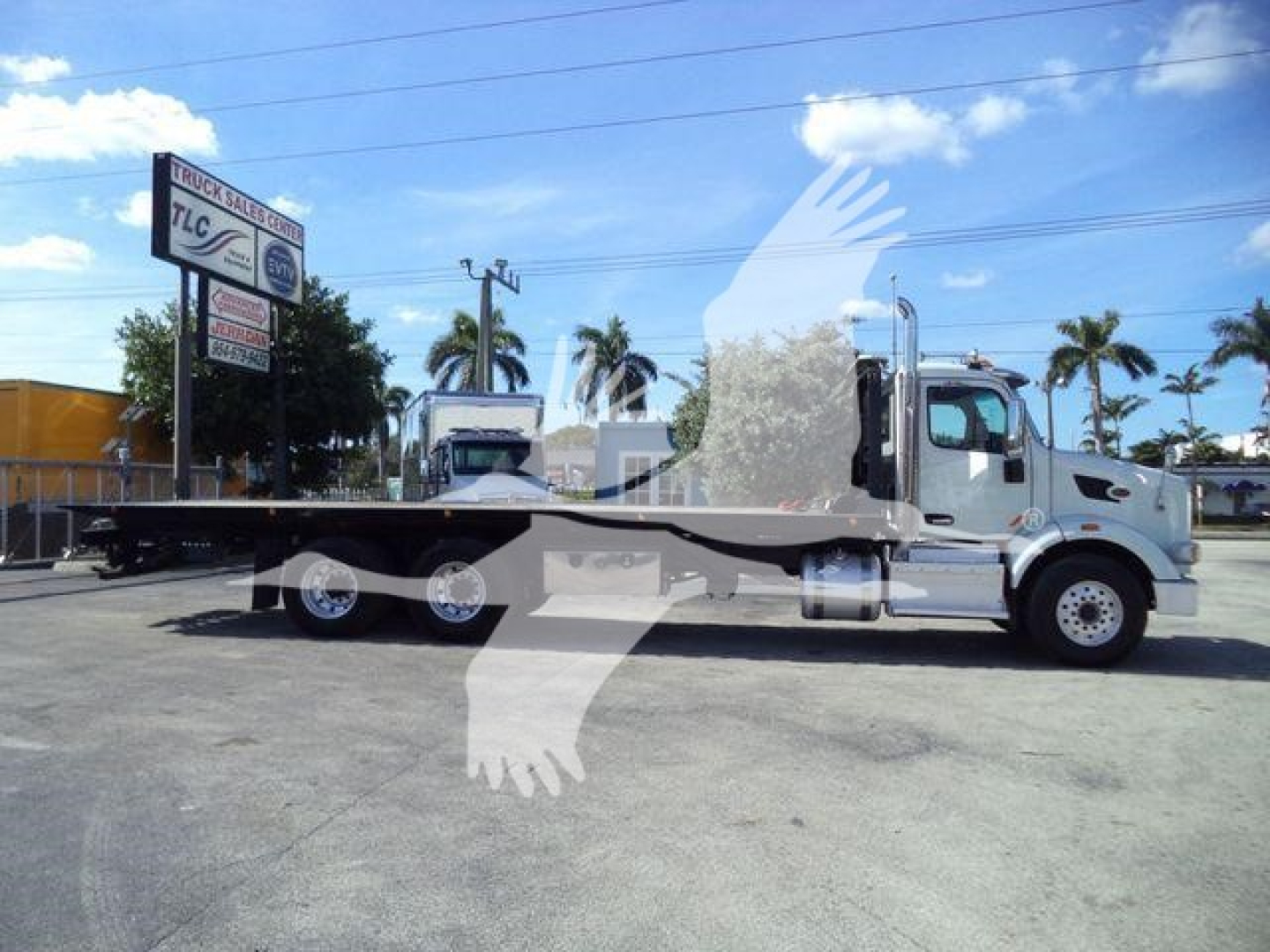 2016 Peterbilt 567 rollback truck side view showing flatbed carrier and cab with chrome accents.